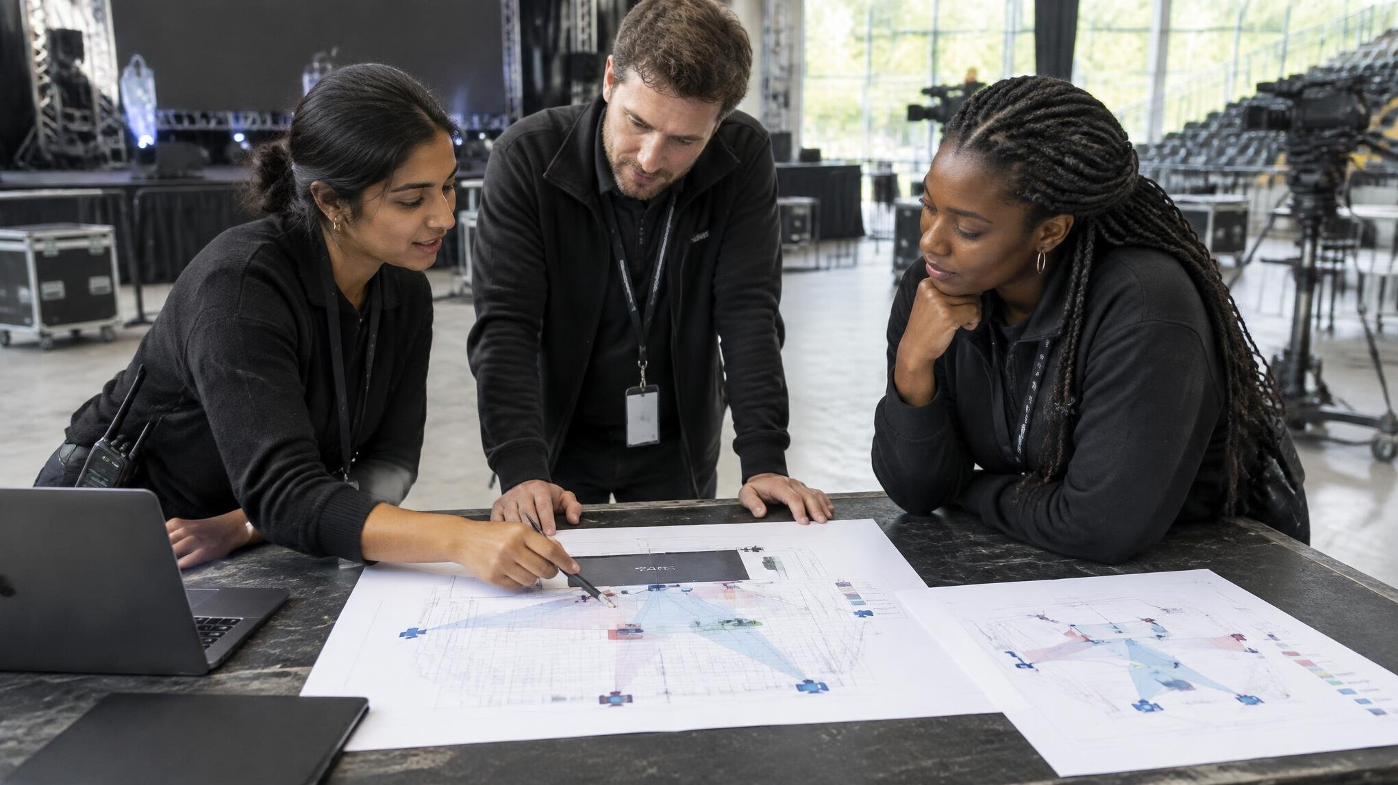 Production team reviewing a stage floor plan during a venue walkthrough